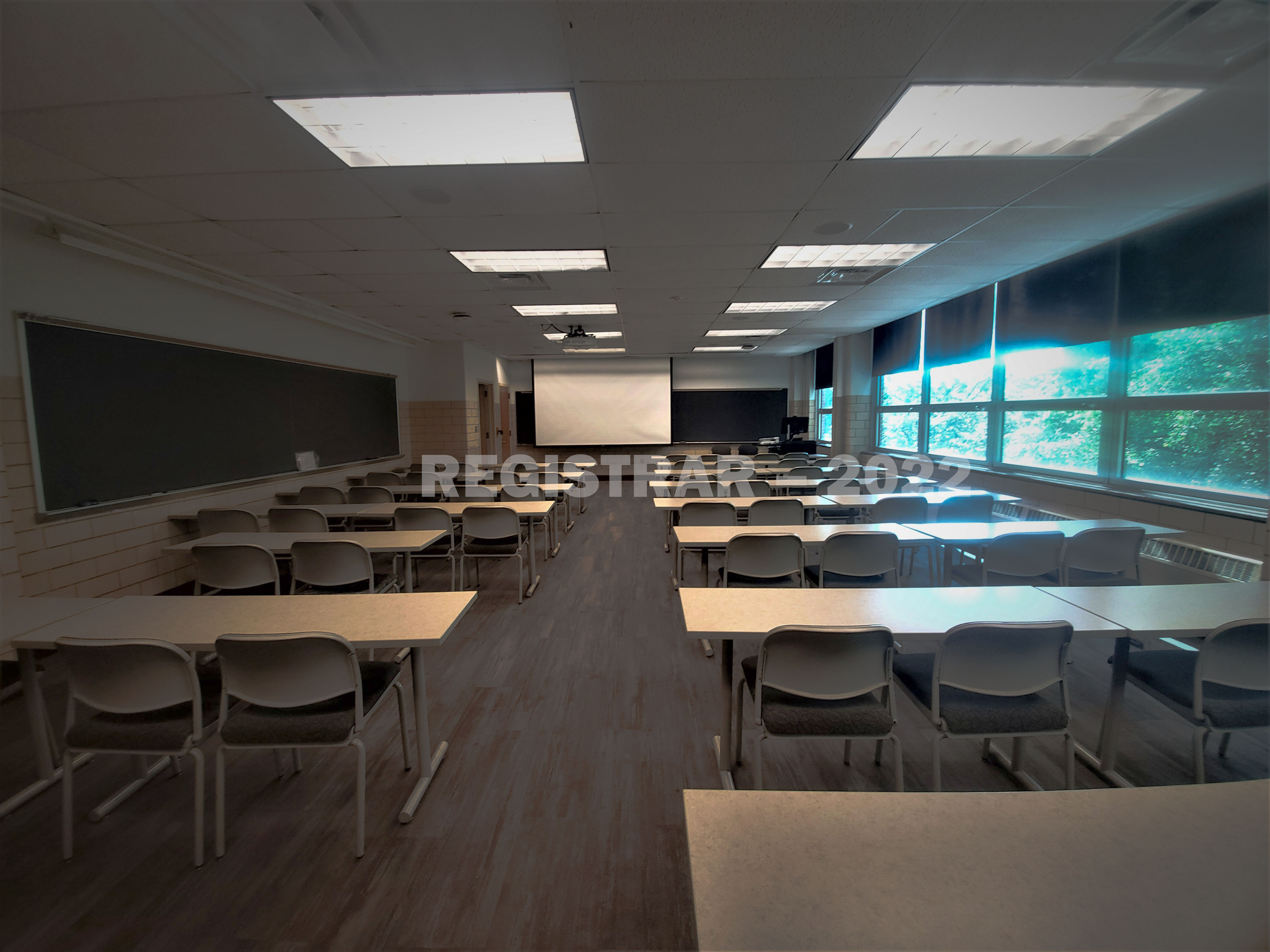 Agricultural Administration room 108 ultra wide angle view from the back of room with projector screen down