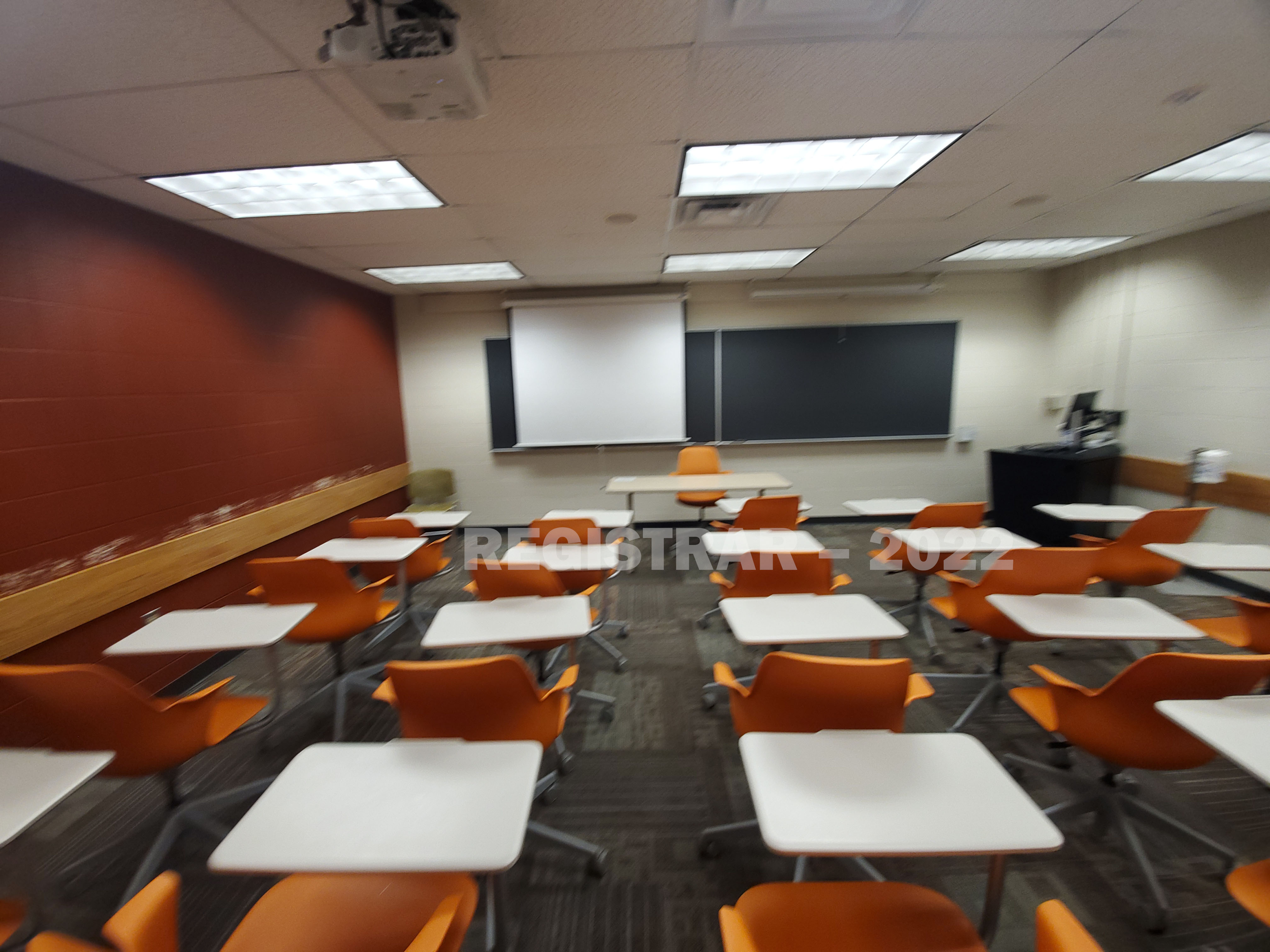 Dulles Hall room 27 ultra wide angle view from the back of the room with projector screen down
