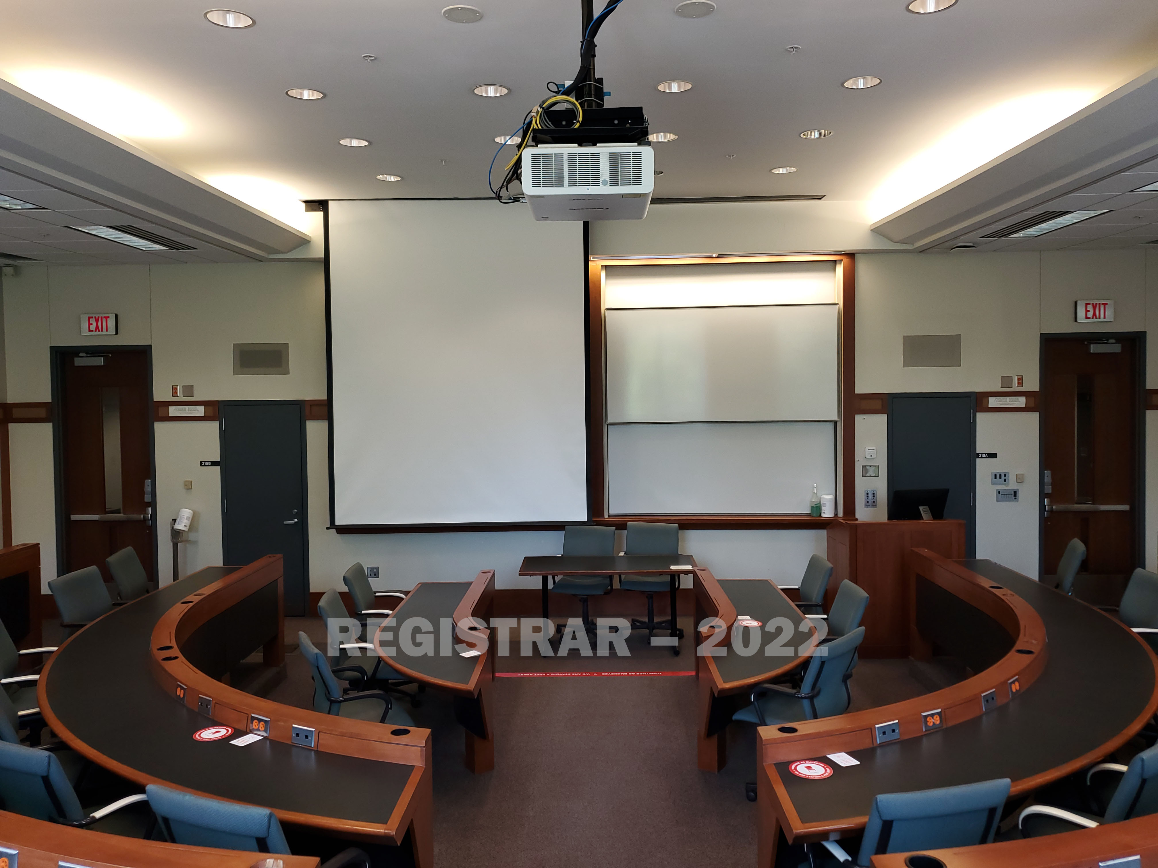 Schoenbaum Hall room 215 view from the back of the room with projector screen down