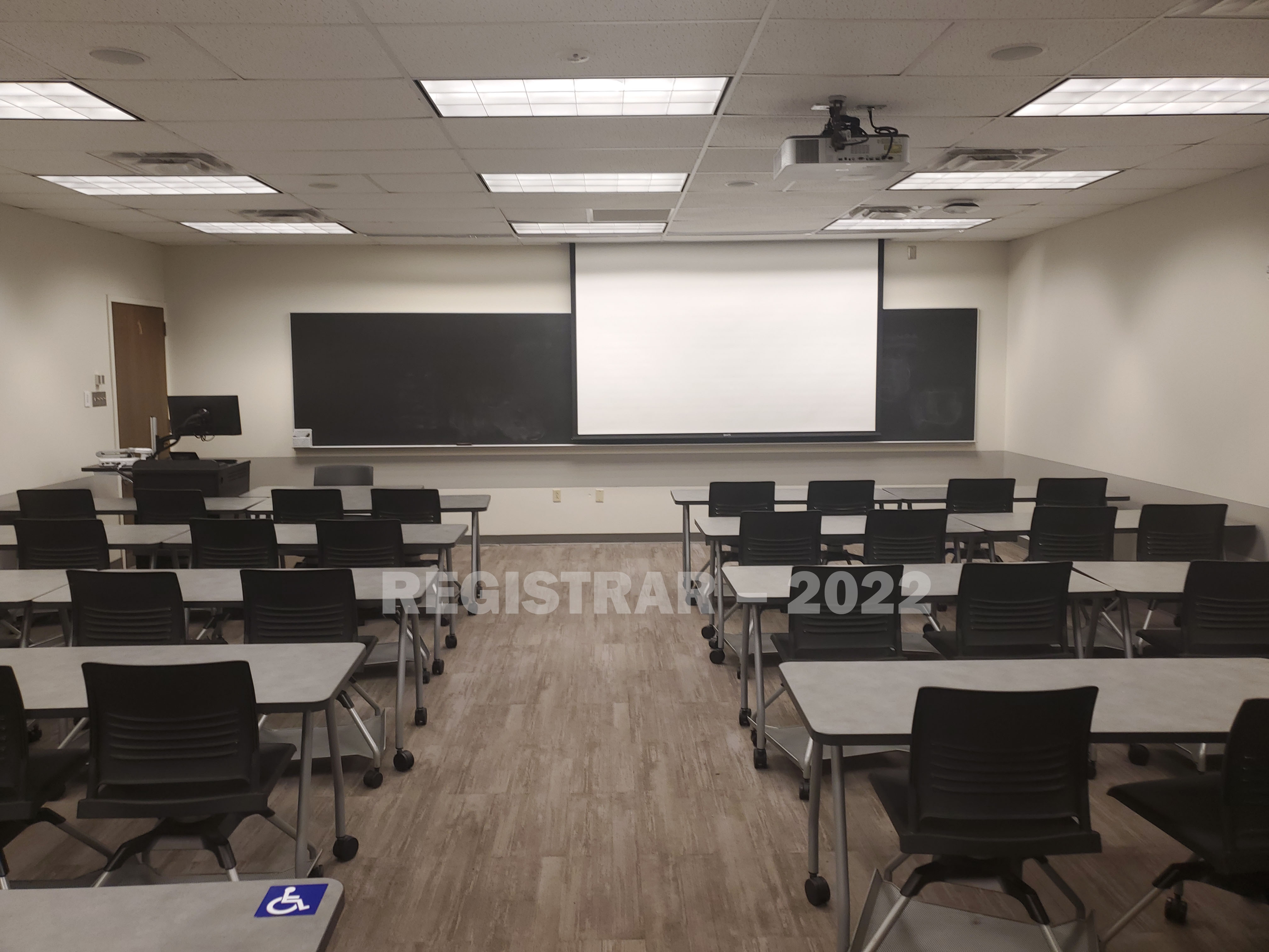 Dreese Lab room 317 view from the back of the room with projector screen down