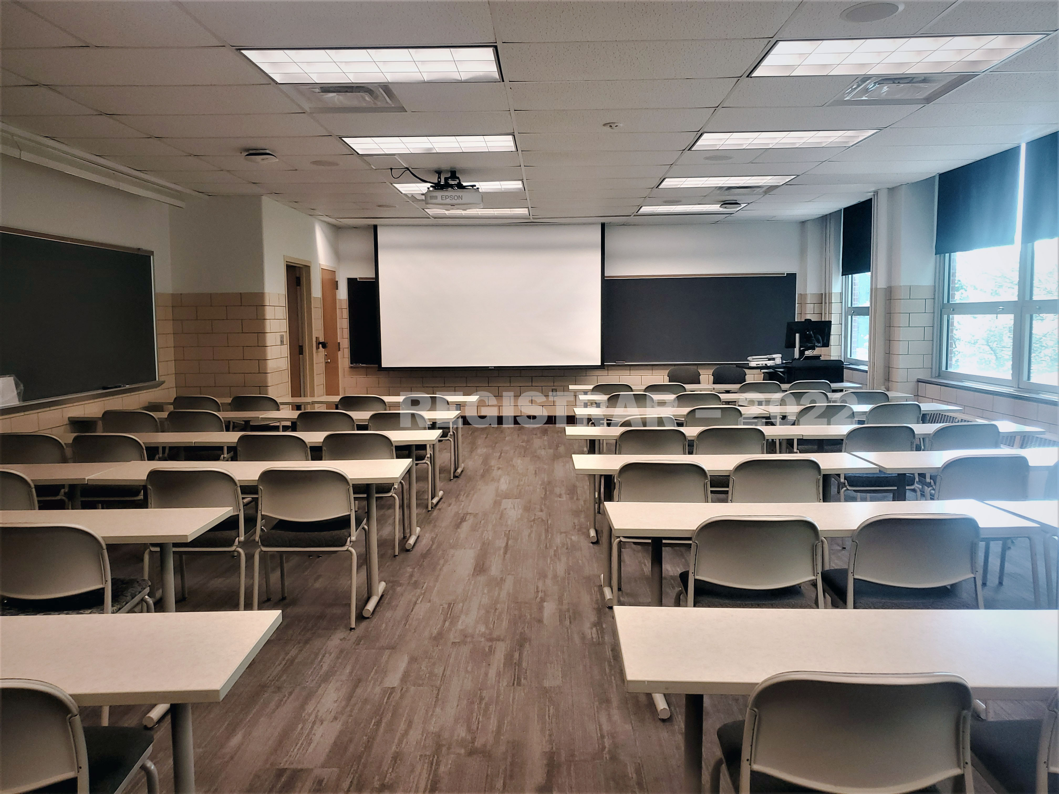 Agricultural Administration room 108 view from the back of room with projector screen down