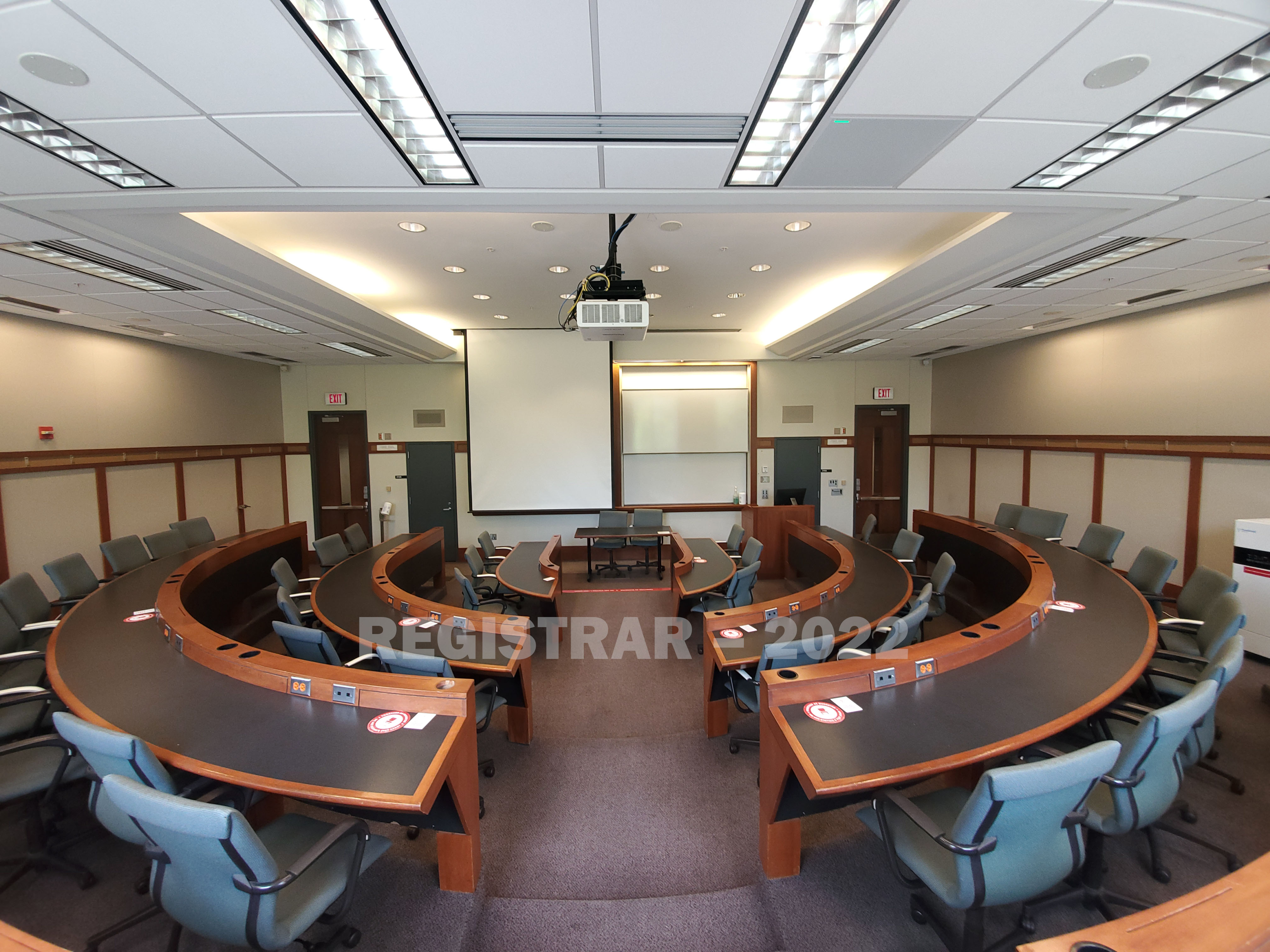 Schoenbaum Hall room 215 ultra wide angle view from the back of the room with projector screen down